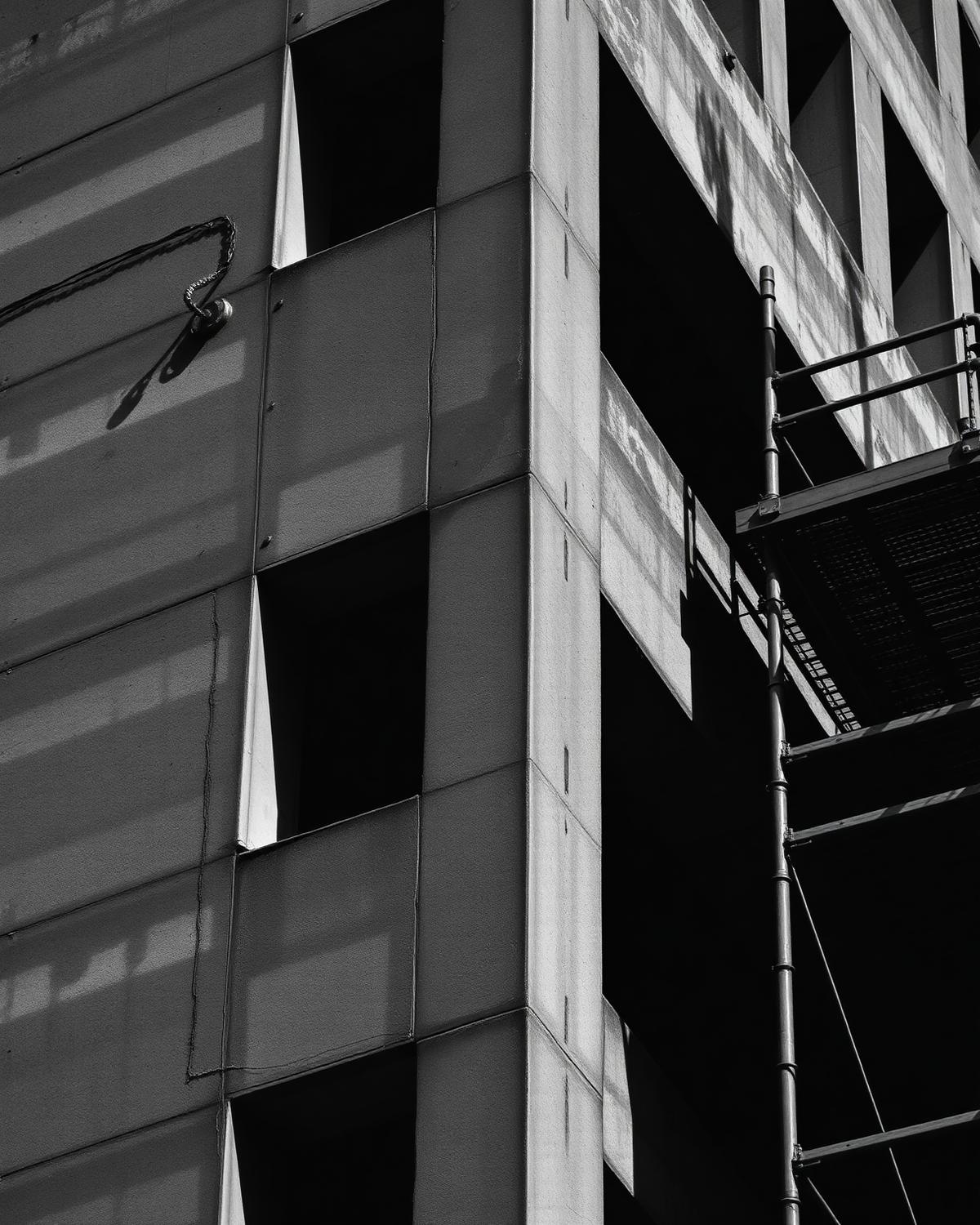 Weathered concrete building facade with scaffolding